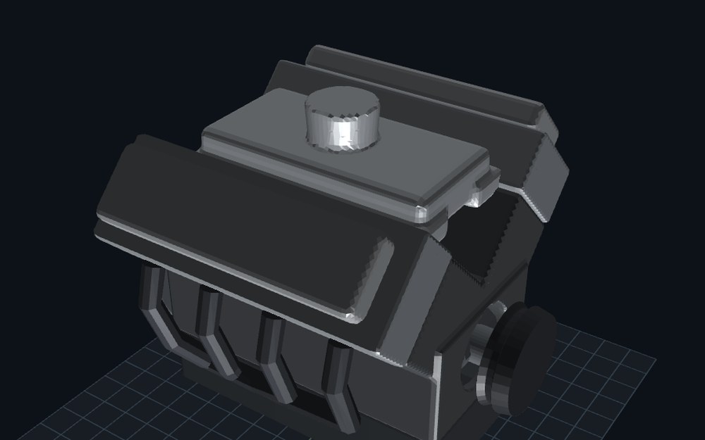 A grey V8 engine blockout in mojulo's live world: two banks of heads and covers, headers, an intake manifold and throttle body on top